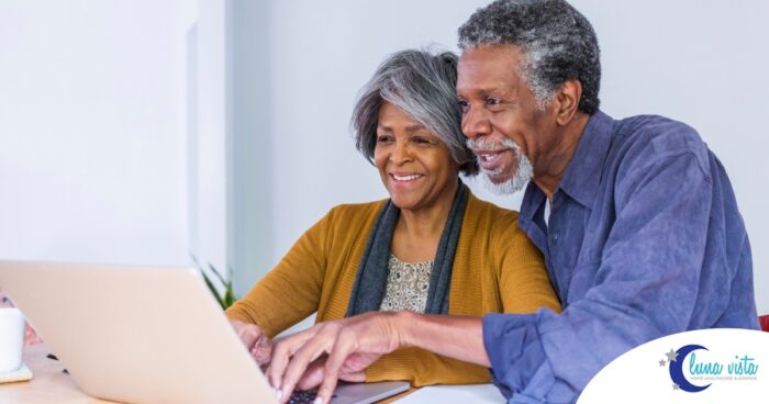 A senior couple looks at a computer, representing older adults looking for payment options for home health care.