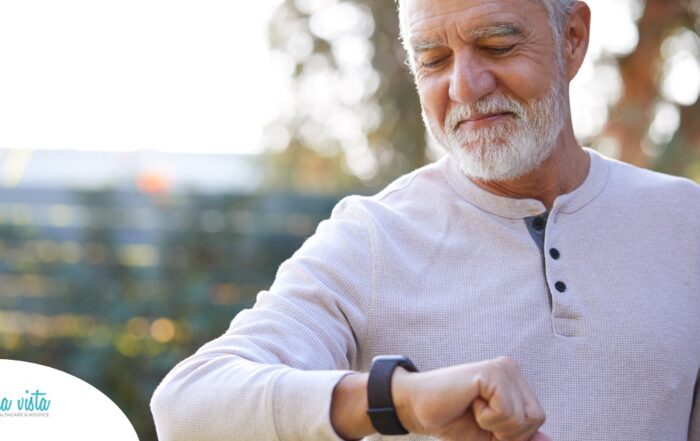 A senior man wears a smart watch, representing one of the many ways smart technology is shaping home health care.