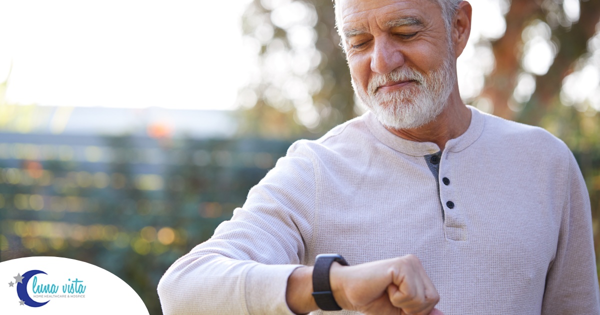 A senior man wears a smart watch, representing one of the many ways smart technology is shaping home health care.