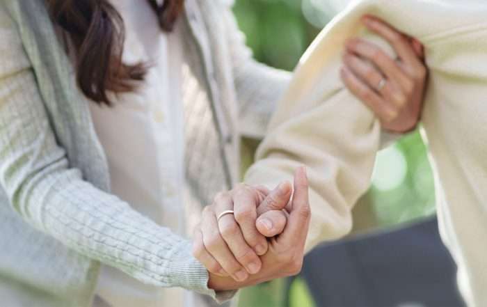 Nursing home, Young caregiver helping senior woman in wheelchair, Volunteer.